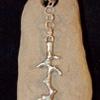 Store bought silver focal piece, river stone, silk cord